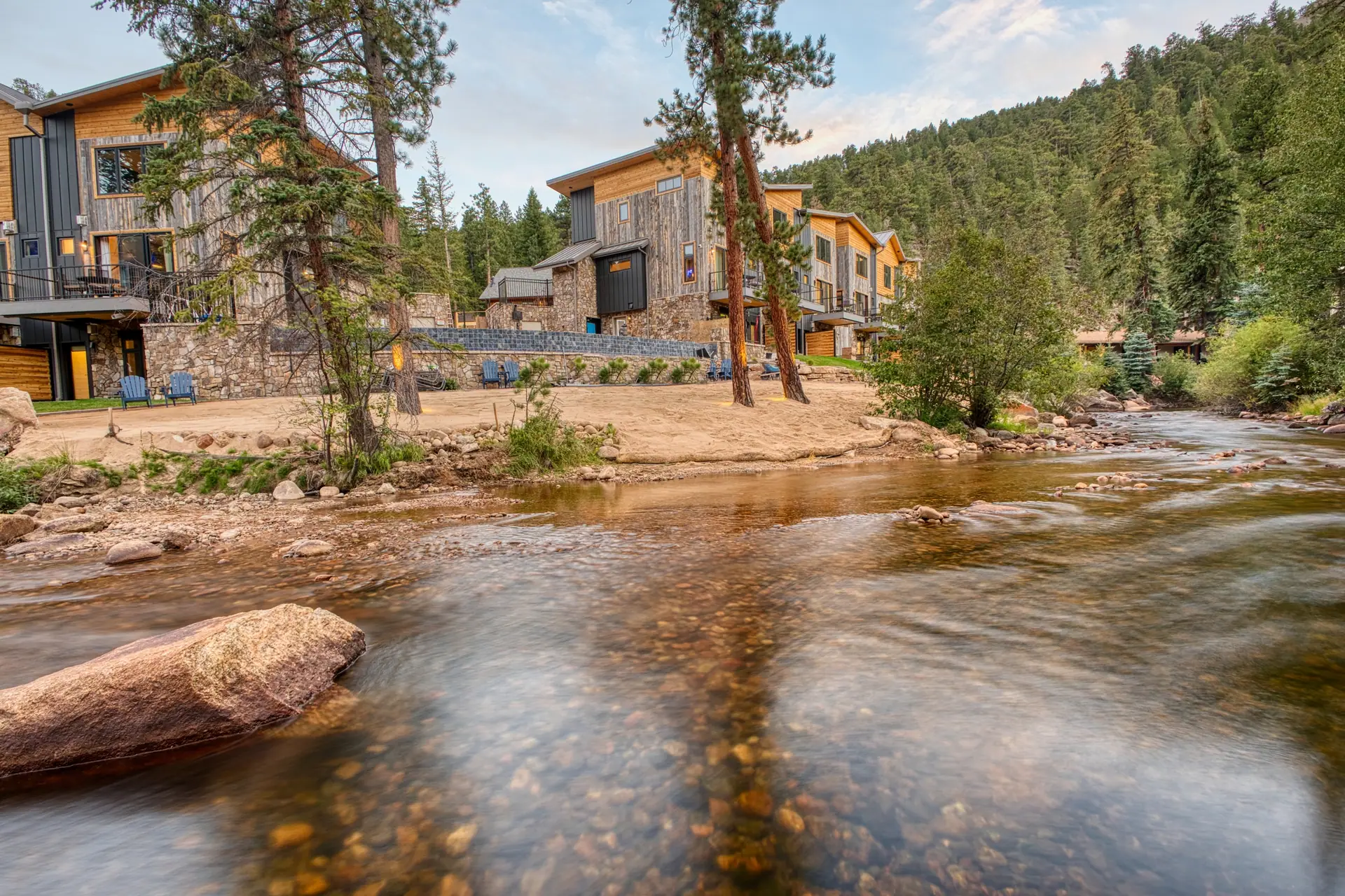 DreamView beside Fall River, surrounded by pines and the Colorado mountains